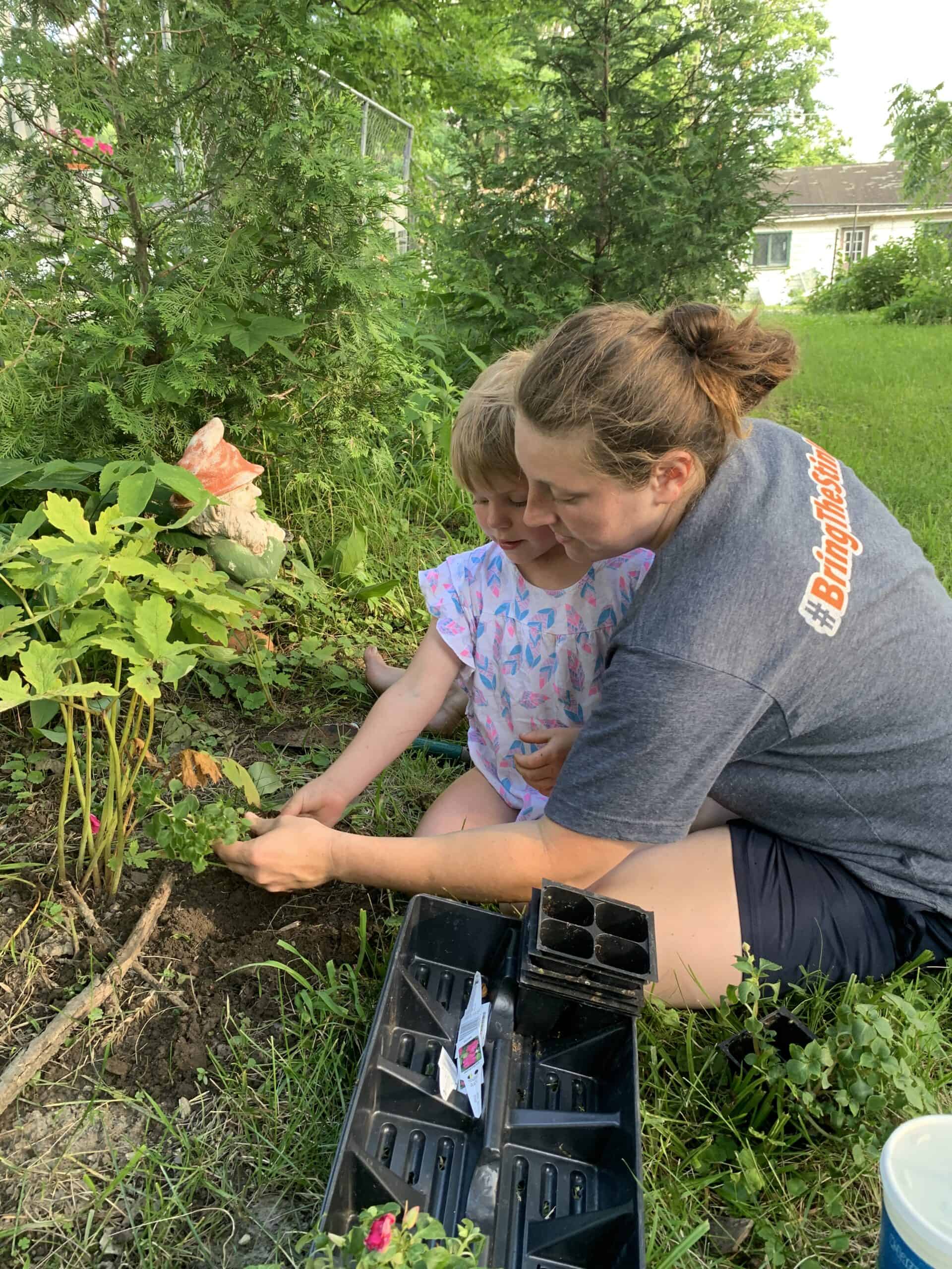 Sarah and her daughter helping plant in the Walnut Garden.