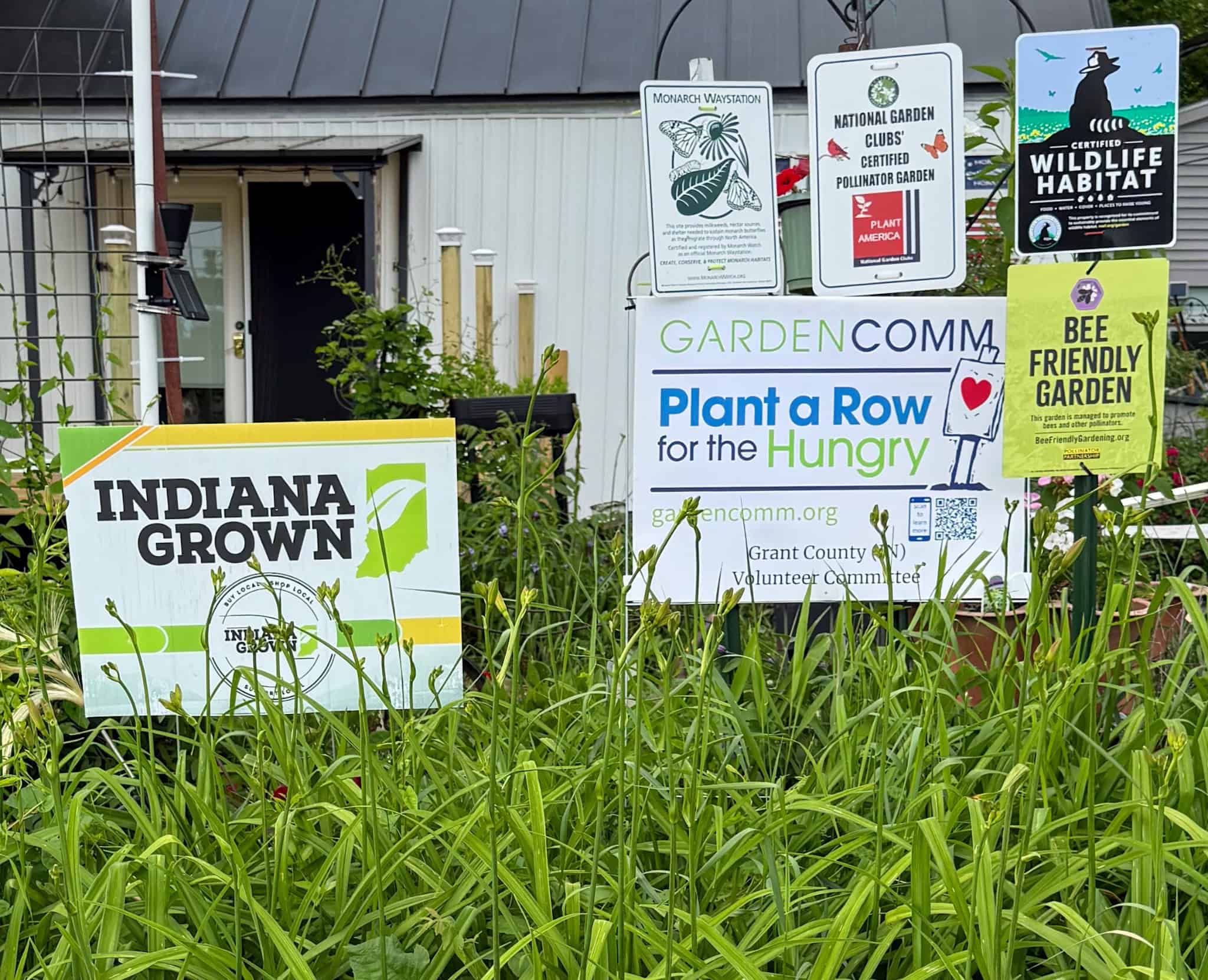 Wildlife habitat, Monarch Waystation, pollinator garden, Bee Friendly Gardening, Indiana Grown and other program signs displayed at Exotic Gardening Farm and Wildlife Habitat.